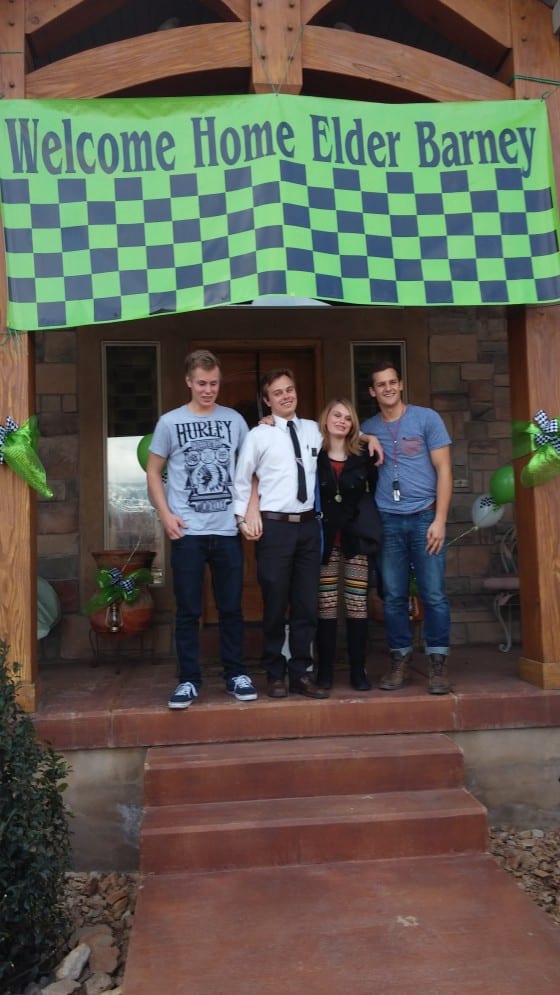 mormon missionary banner hung with family