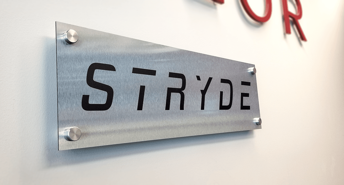 Example of brushed aluminum sign with standoffs.