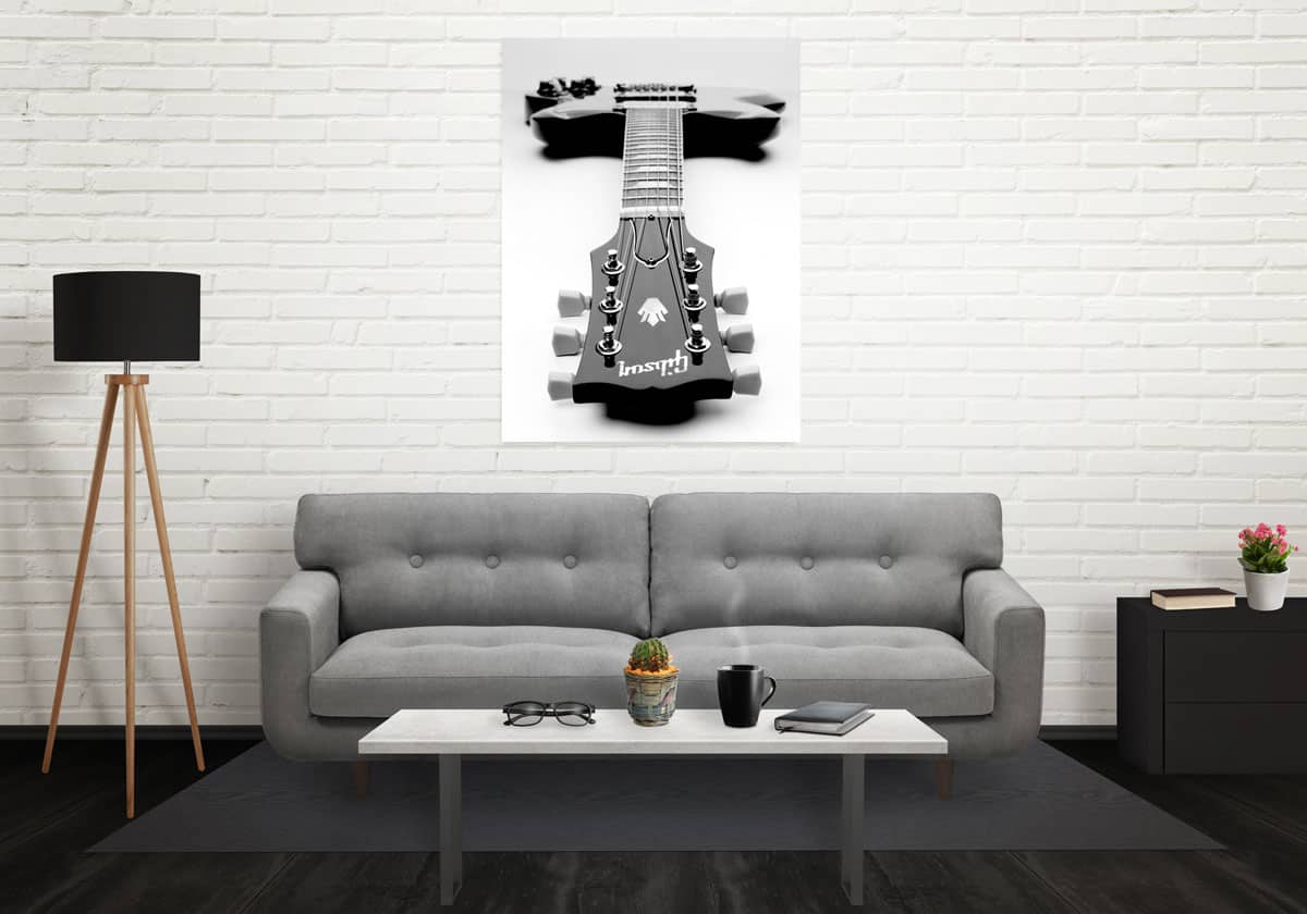 Poster of guitar hanging on a wall in a living room setting