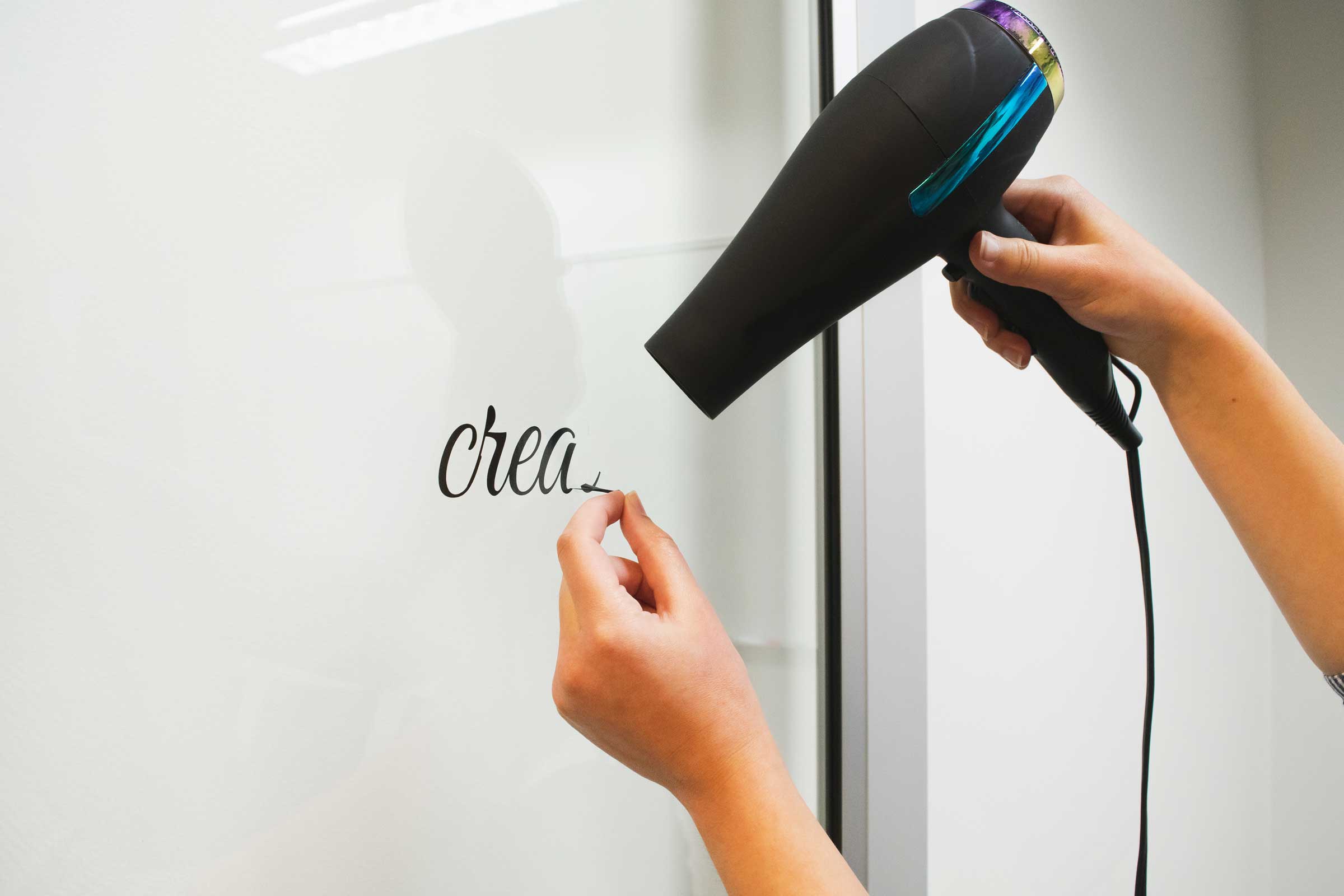 Using a blow dryer to remove hard-to-remove vinyl lettering