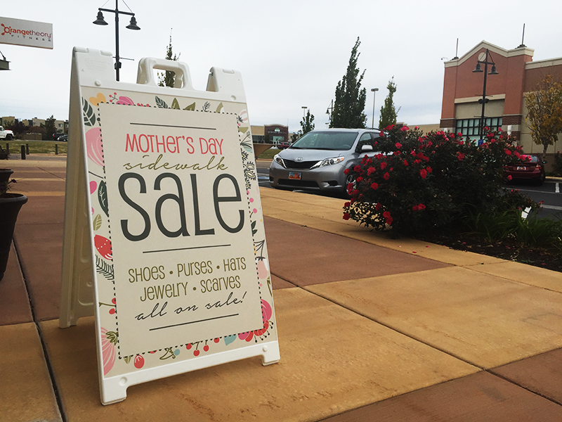 White Plastic A Frame with Mother's Day sale graphic and outside establishment